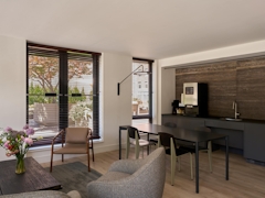 Thumbnail of The Nicole: 5C a living room filled with furniture and a large window