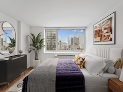 Thumbnail of Atlas New York: 36B a living room filled with furniture and a large window