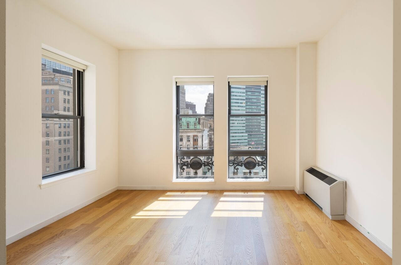 a room filled with furniture and a large window