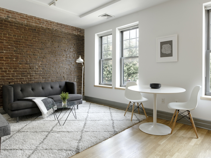 a living room filled with furniture and a large window