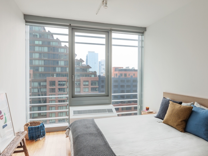a living room with a bed and a window
