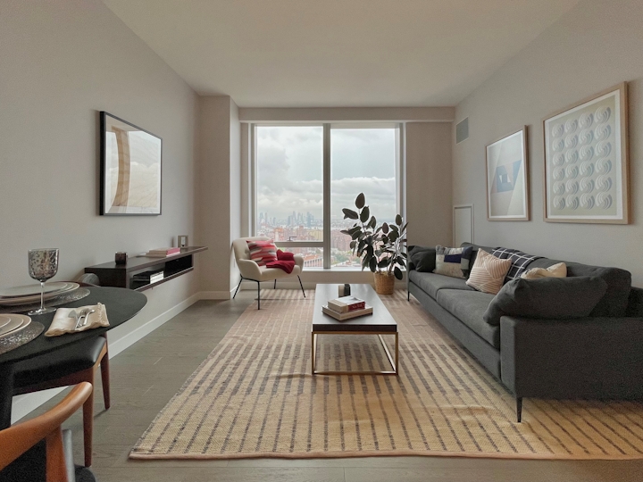 a living room filled with furniture and a large window