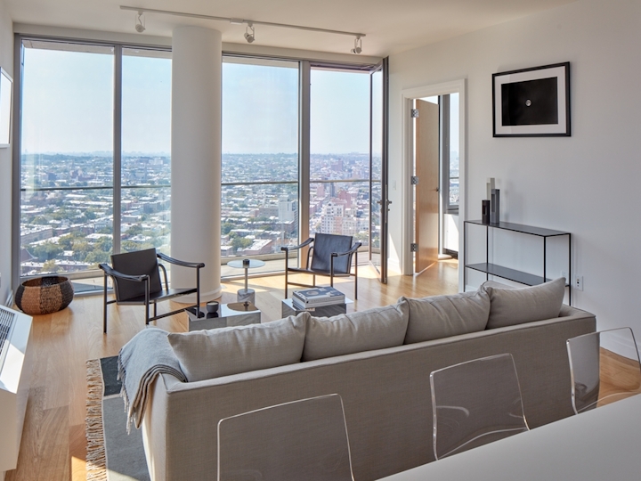 a view of a living room filled with furniture and a large window
