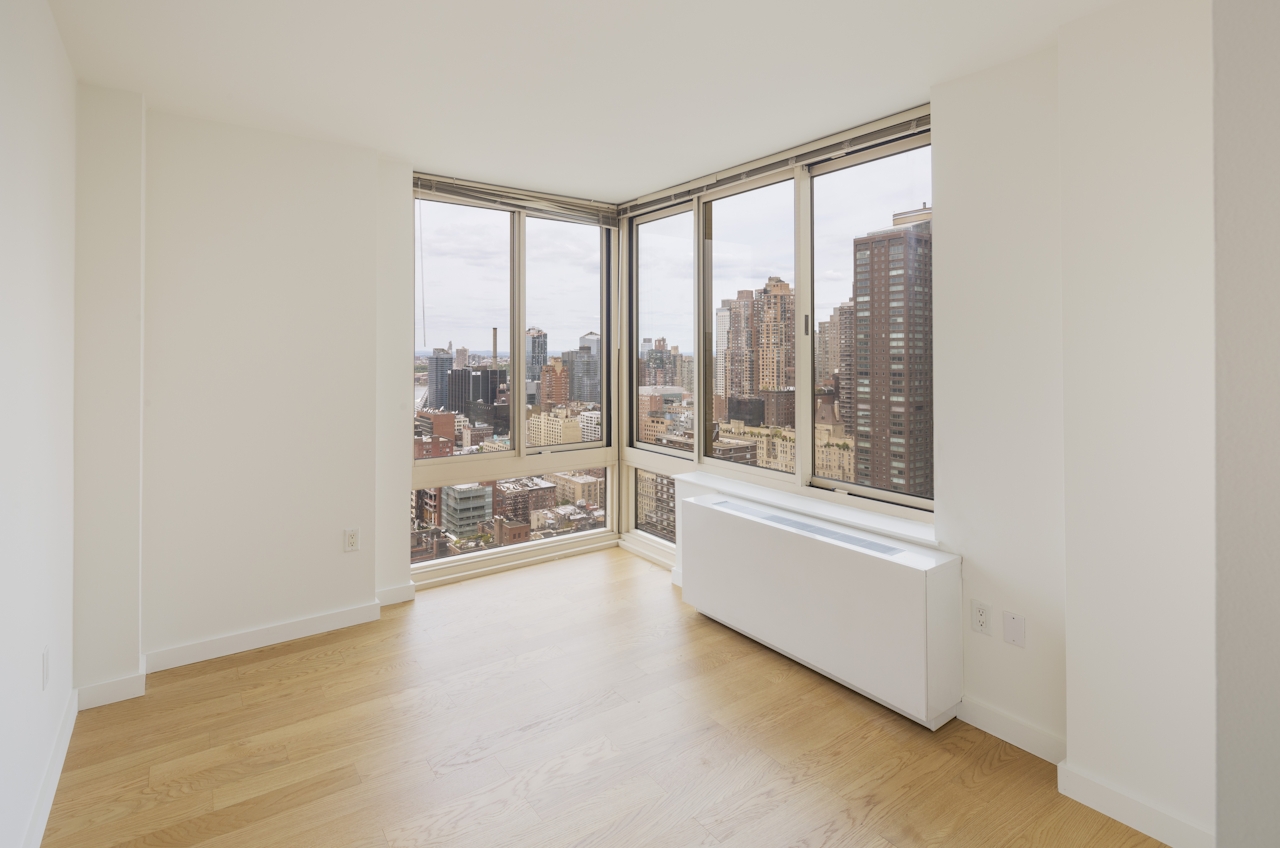 a room filled with furniture and a large window