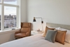 a view of a living room with a bed and a window
