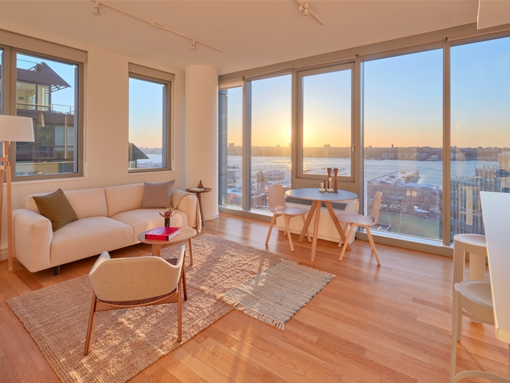 a view of a living room filled with furniture and a large window