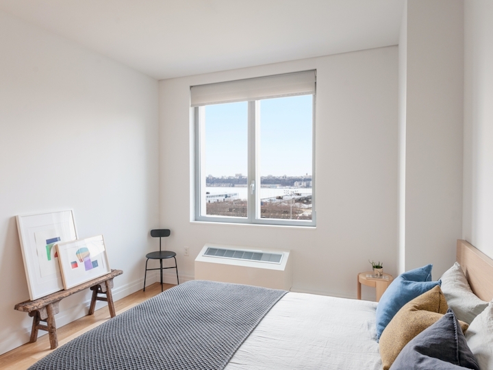 a bedroom with a bed and a window