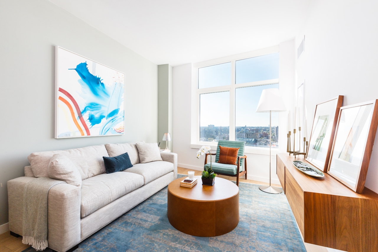 a living room filled with furniture and a large window