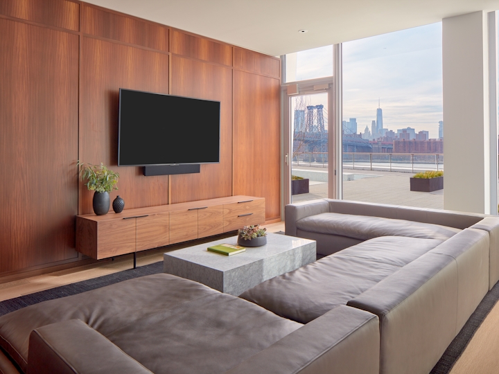 a view of a living room filled with furniture and a large window