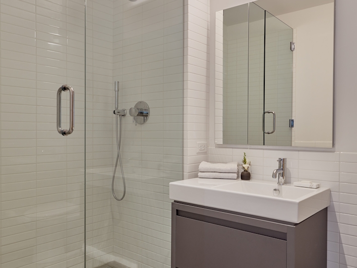 a shower that has a sink and a mirror