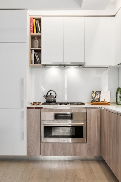 a stove top oven sitting inside of a kitchen