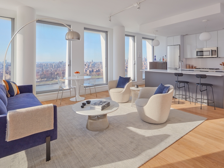 a living room filled with furniture and a large window