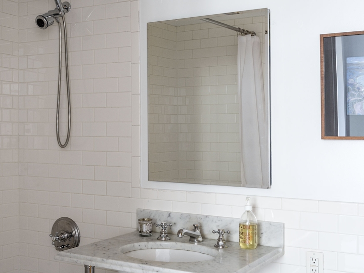 a room with a sink and a mirror