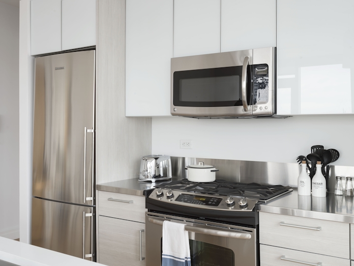 a stove top oven sitting inside of a kitchen