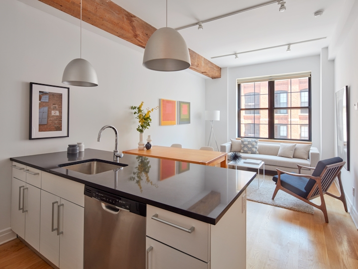 a kitchen with a stove top oven sitting inside of a room